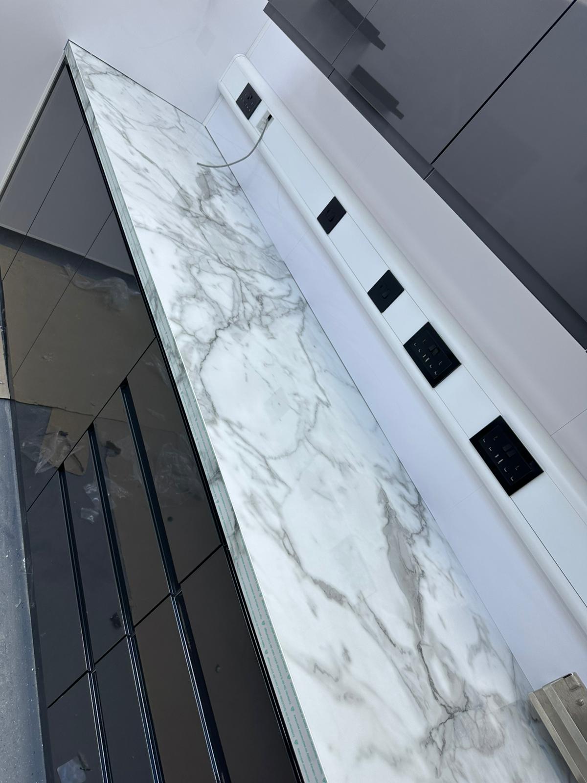 A striking view of a modern kitchen counter, bathed in the soft glow of ambient light