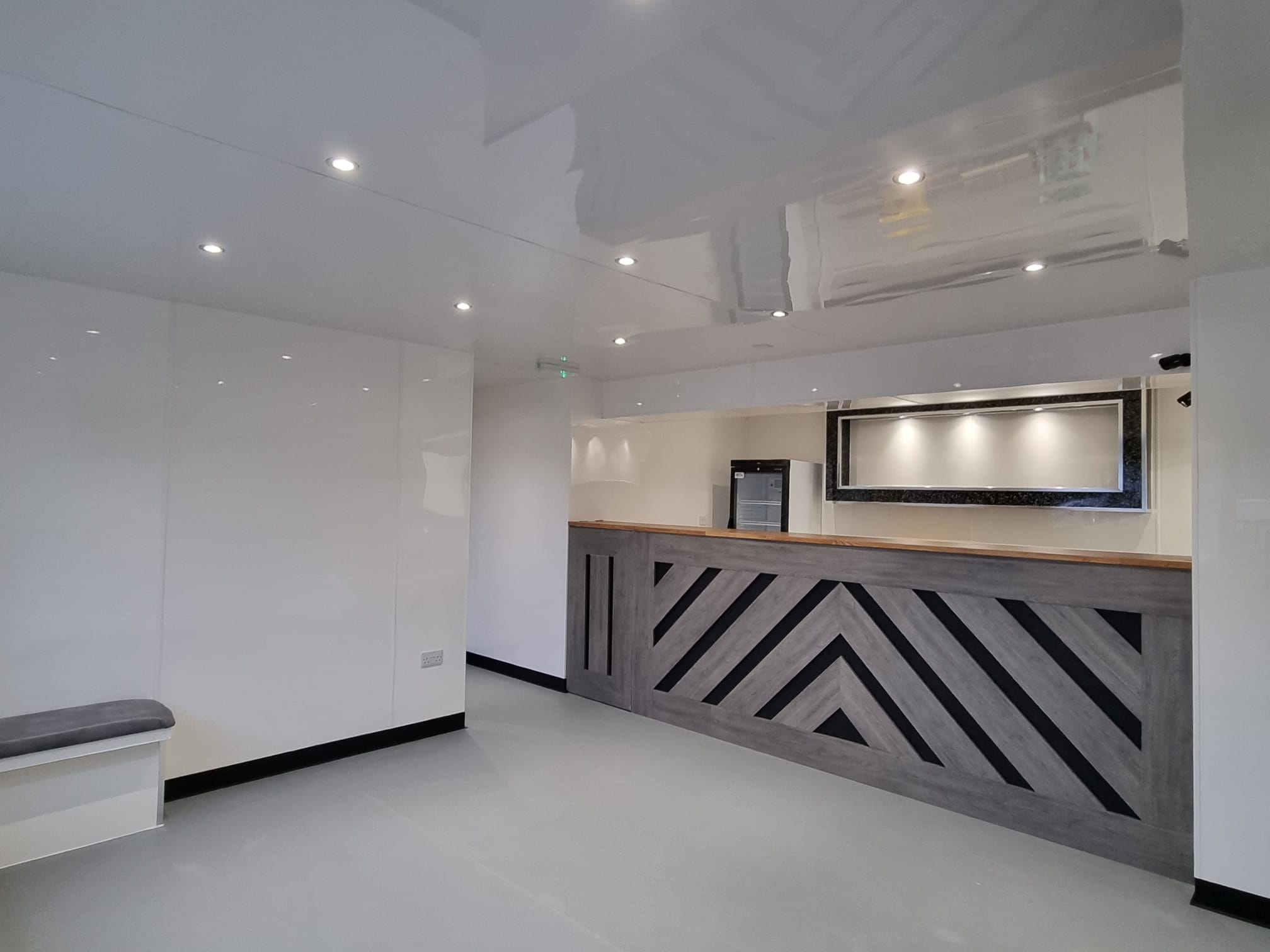 A modern office space bathed in natural light from a large window on the right wall