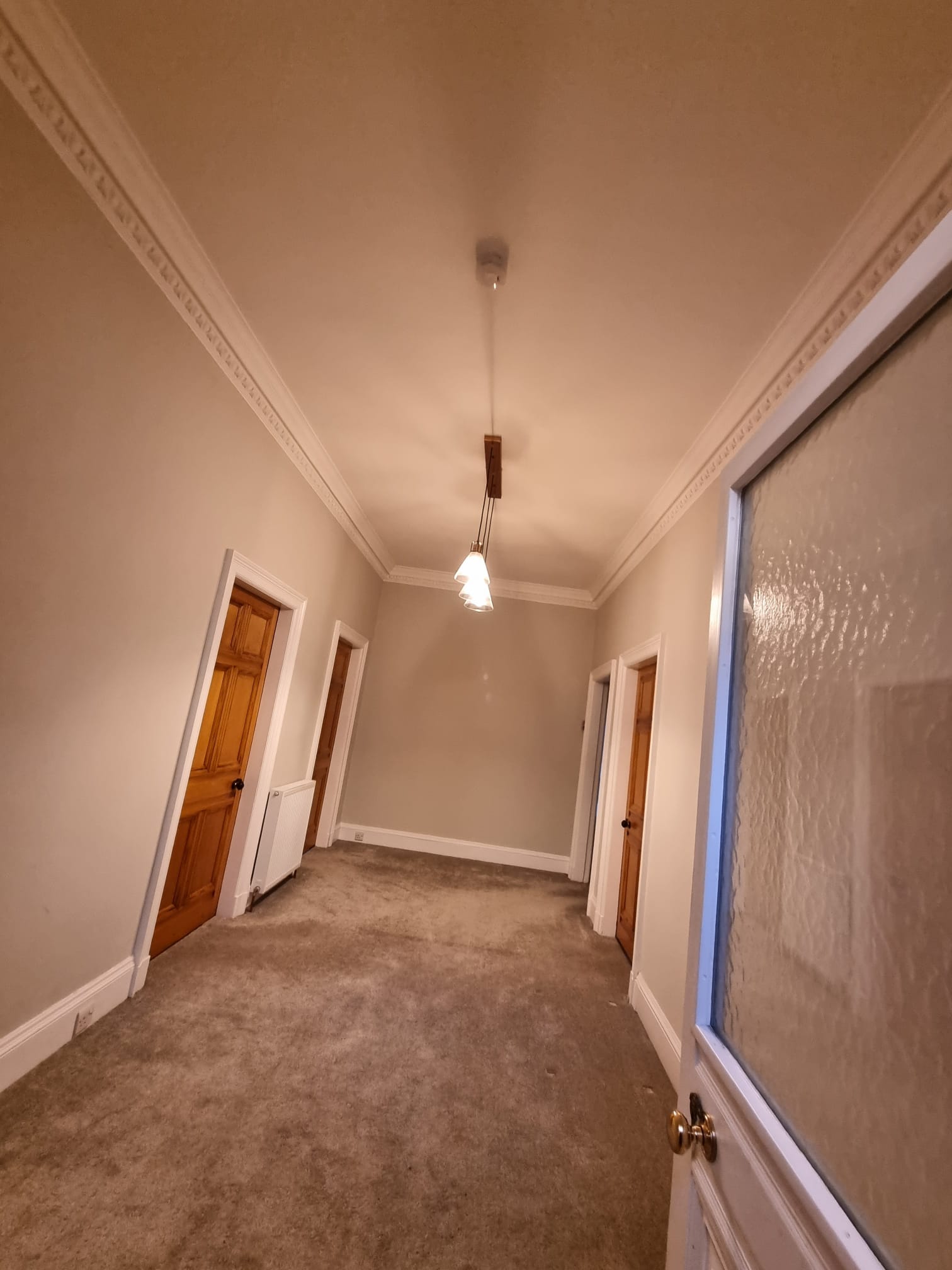 A serene and well-lit hallway in a home or apartment building