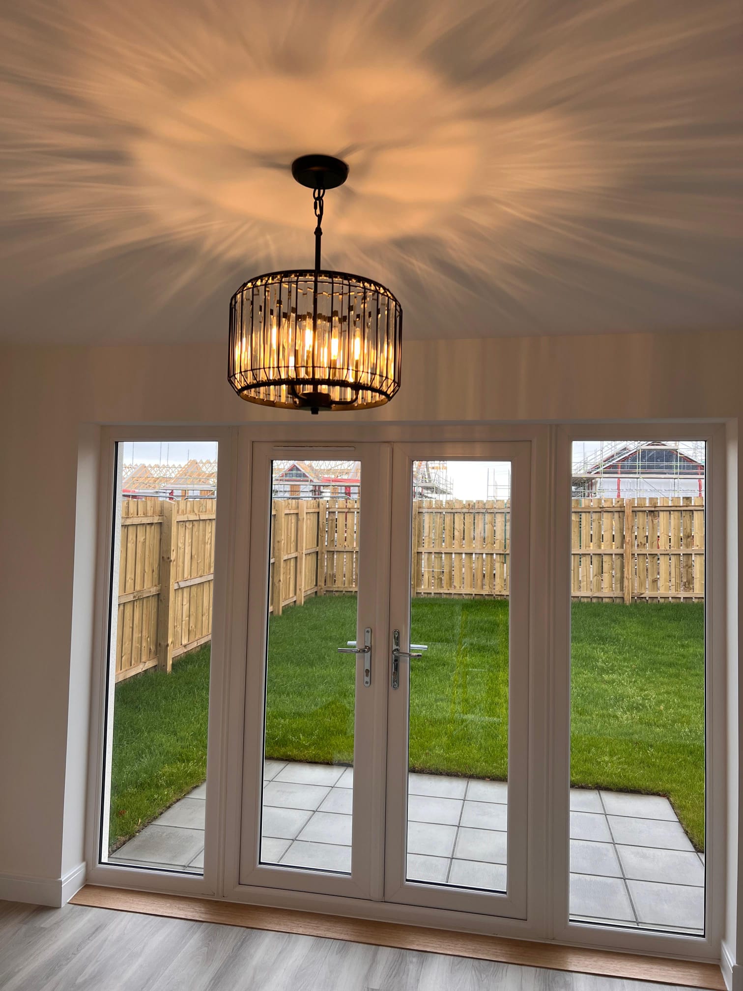 A serene indoor space bathed in soft light filtering through a large window with white frames